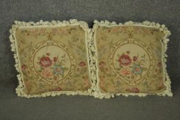 A pair of Aubusson type square cushions, depicting many flowers, with tassels around the edge. L.