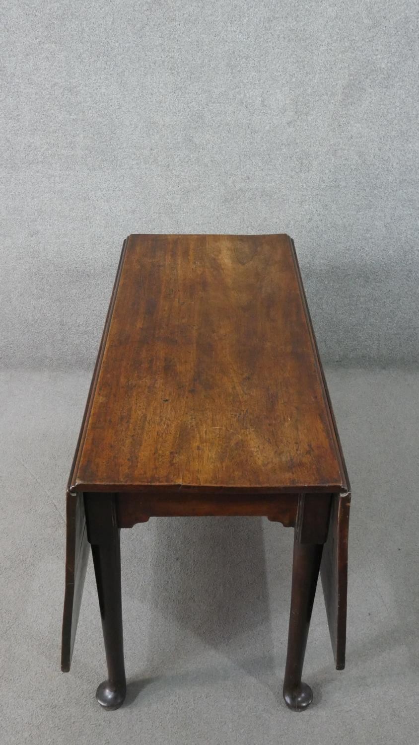 A mid 18th century mahogany drop leaf dining table, with a rectangular top, the legs with pad - Image 2 of 7