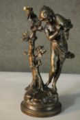 A bronze finished spelter figure after A. Moreau titled 'Fontaine et Ruisseau' of a water carrier,