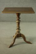 A fruitwood occasional table, with a square top, on a turned stem, with tripod feet. H.68 W.59 D.