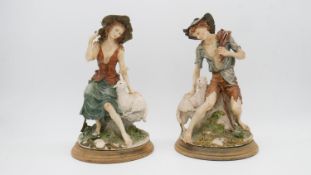 Two hand painted Capodimonte porcelain Giuseppe Armani figurines one of a shepherd girl with sheep