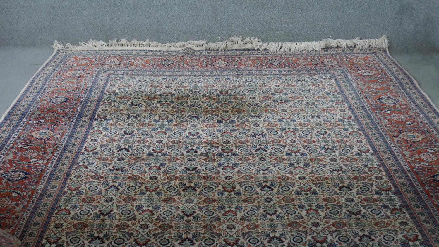 A beige ground hand made Persian Moud carpet with all over lotus and serrated palm decoration. no