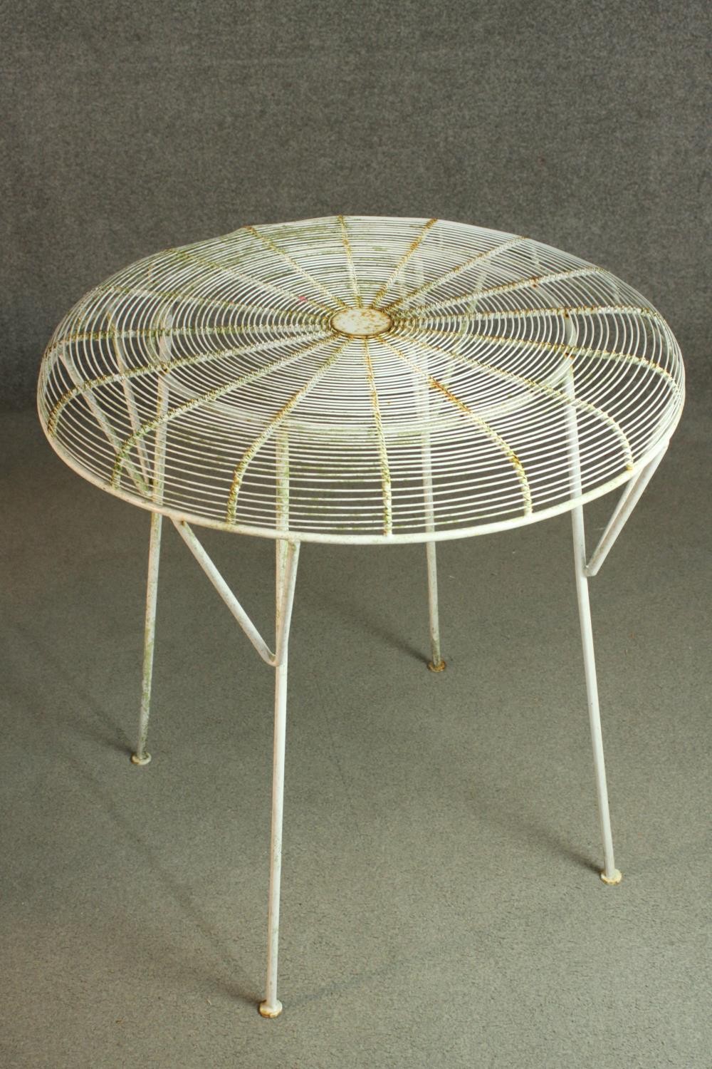 A white painted iron garden set, comprising a circular table and four stools. H.72 Dia.70cm (table) - Image 3 of 7