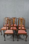 A set of eight Queen Anne style fruitwood dining chairs, with vase splat backs, over salmon pink