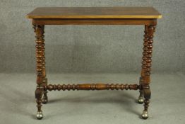 A Victorian figured walnut stretcher table, the quarter veneered top on bobbin turned legs joined by