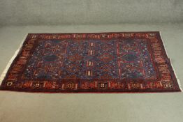 A blue ground hand made Persian Nahvand rug. L.215 W.136cm