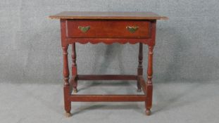 An 18th century painted oak side table, the rectangular top with a moulded edge, over a single