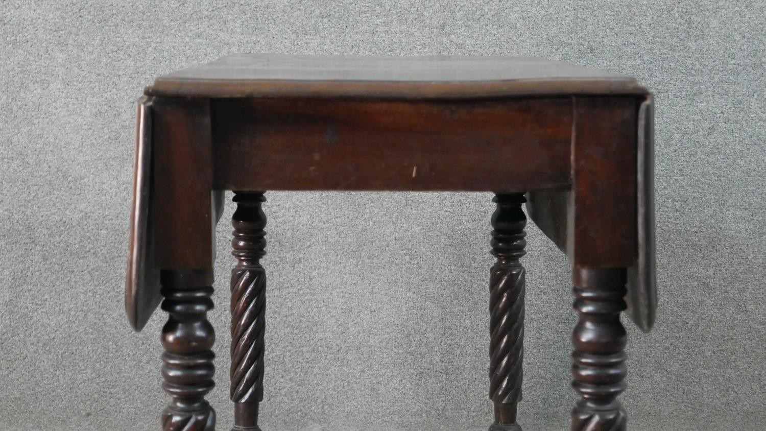 A Victorian mahogany drop leaf dining table, with turned and wrythen legs. H.70 W.93cm (Extended) - Image 4 of 7