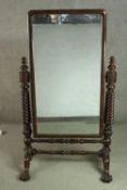 A William IV mahogany cheval mirror, with a rectangular bevelled plate, supported by two rope