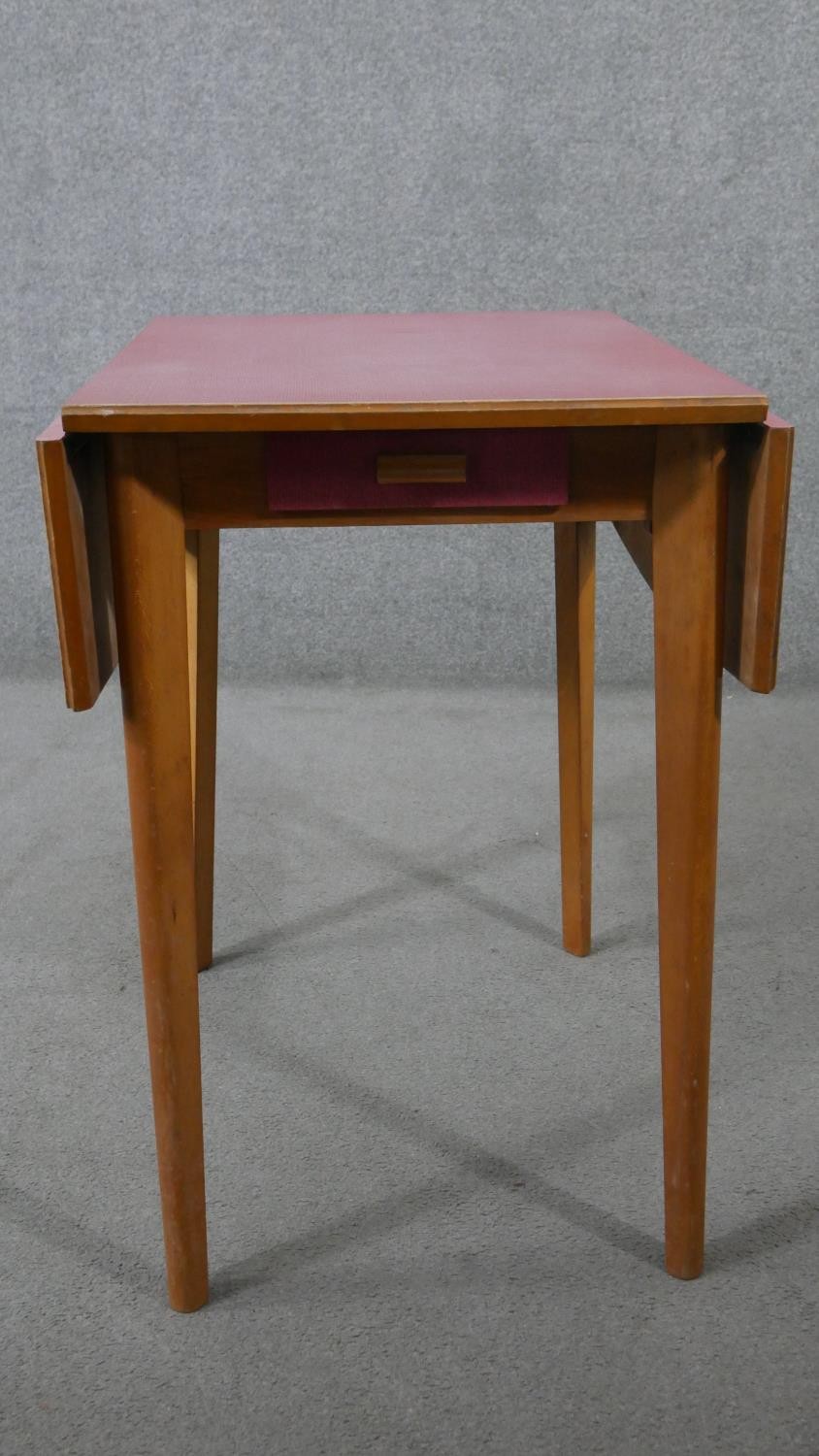 A 1950s drop leaf beech kitchen table, with a pink formica top and a single end drawer. H.78 W.47 - Image 5 of 5