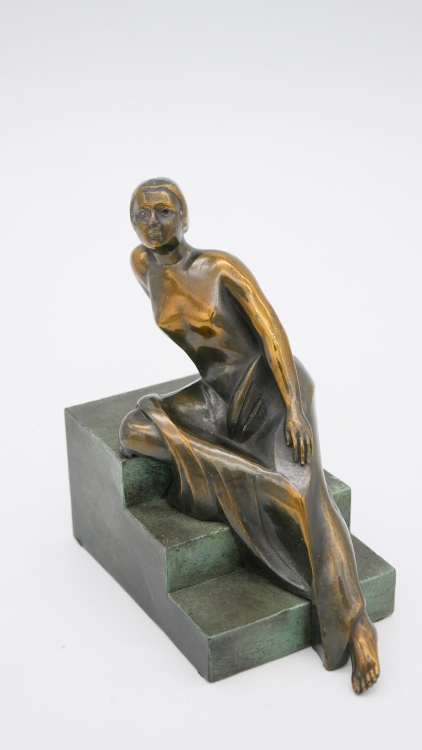 An Art Deco style patinated bronze of a woman reclining on steps. Unsigned. H.15 W.15 D.8cm - Image 2 of 7