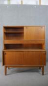 A circa 1960's Nathan Furniture teak sideboard, with shelves and a fall front over two short