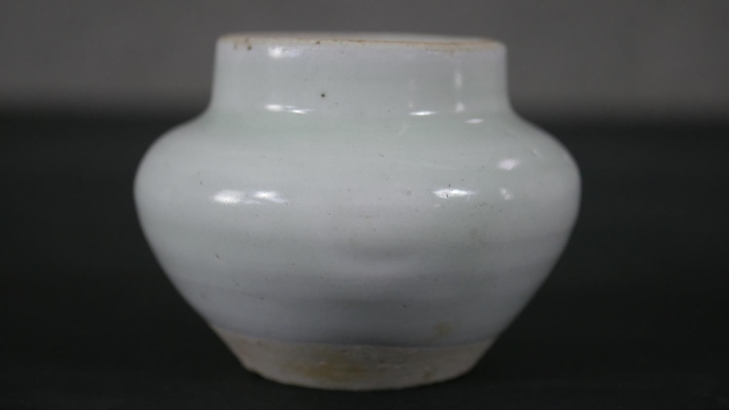 A Chinese celadon glaze ceramic vase, unglazed foot. H.7 W.8cm