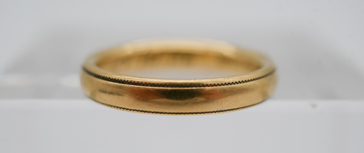 A size Q 18 carat yellow gold court shaped wedding band, engraved to the interior 'REF. HBS, 25.10.