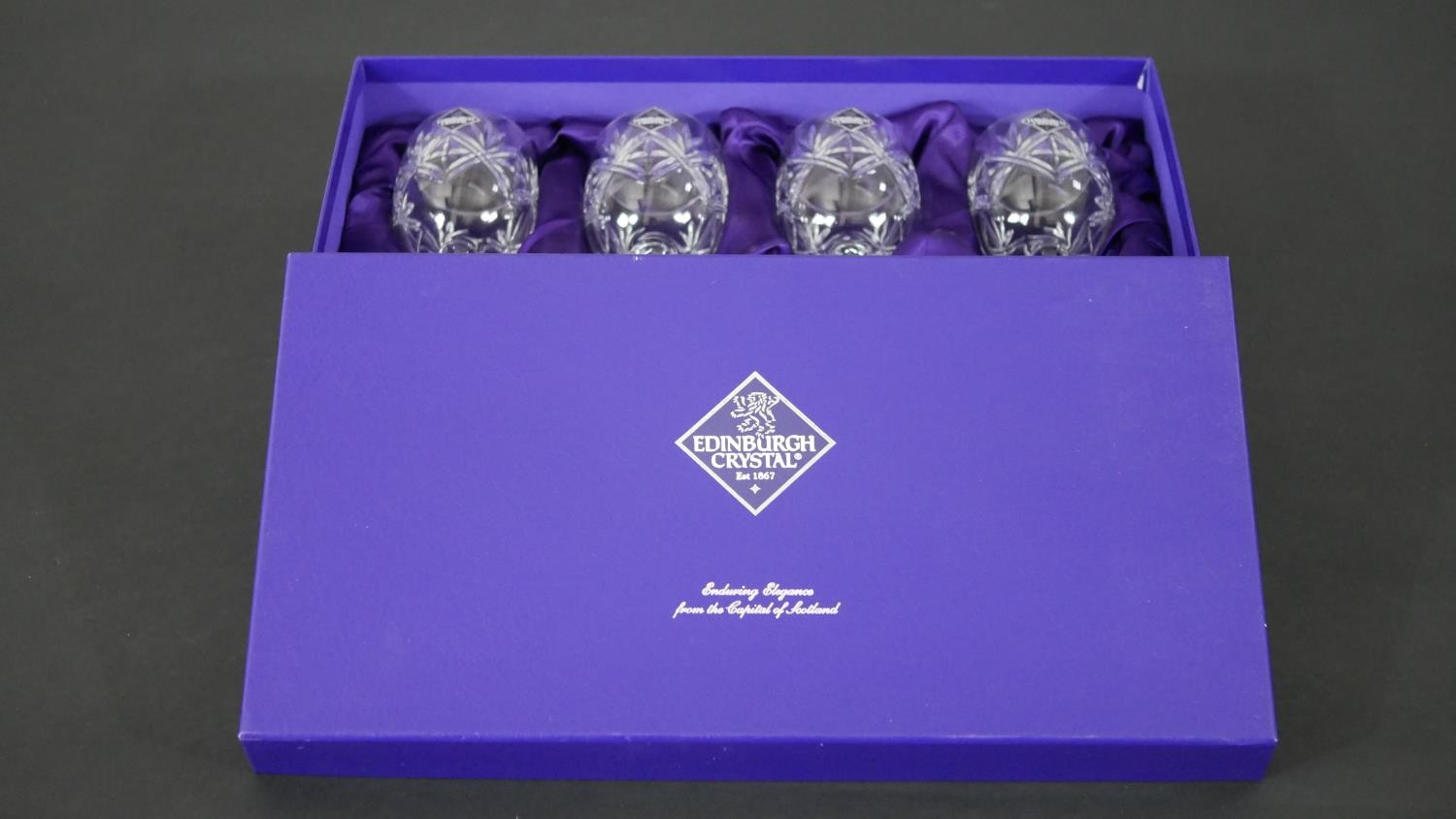 A boxed set of four Edinburgh crystal wine glasses. H.17 Diam.6.5cm