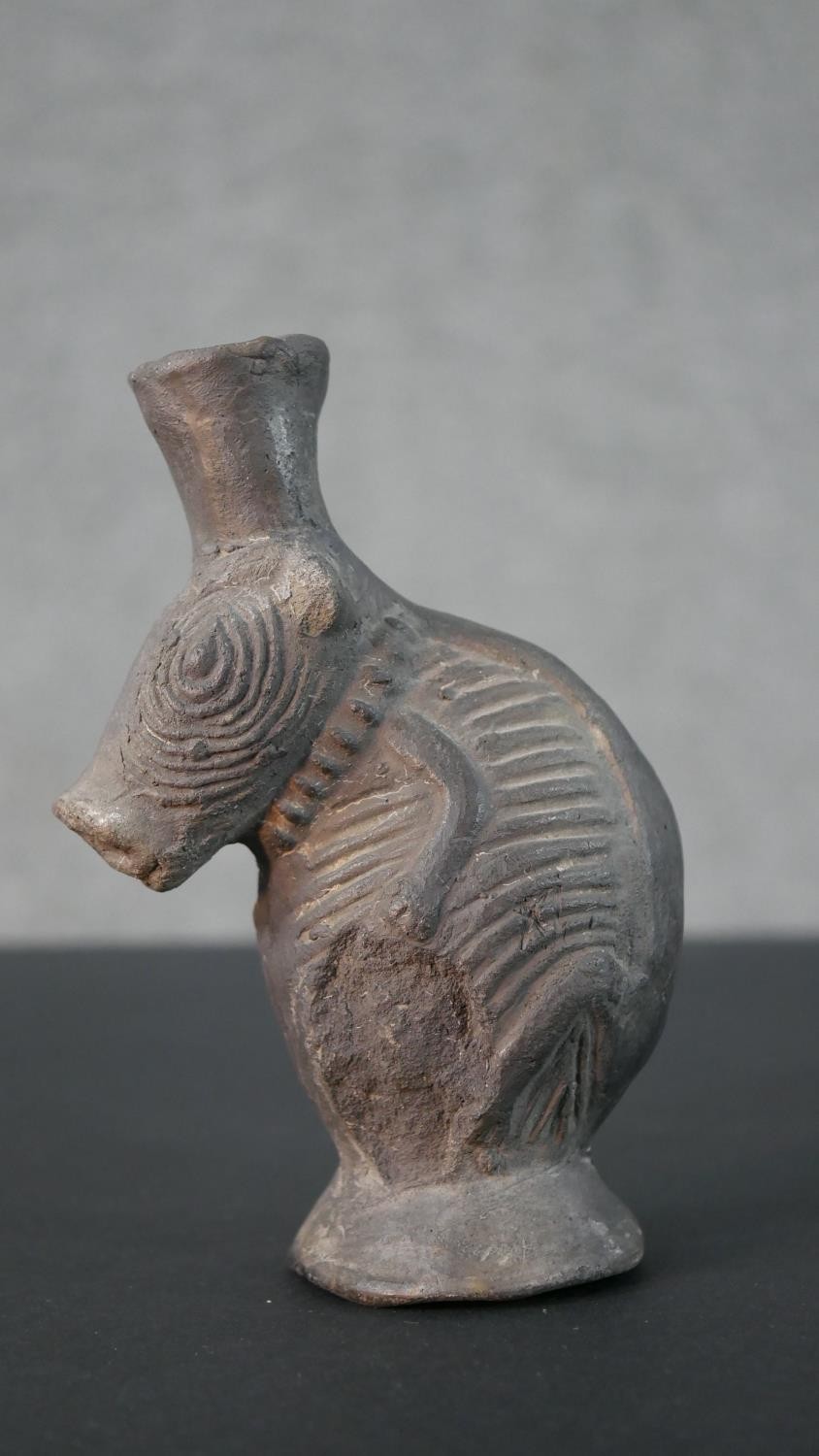 A pre-Colombian style clay vase in the form of an armadillo with relief design. H.16 W.11cm
