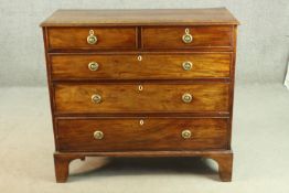 A George III mahogany chest, the rectangular crossbanded top above two short over three long