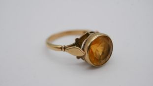 A 9ct yellow gold and citrine set dress ring, the round mixed cut citrine with an approximate weight