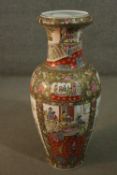 A very large hand painted Cantonese porcelain vase, decorated with panels of birds, flowers and