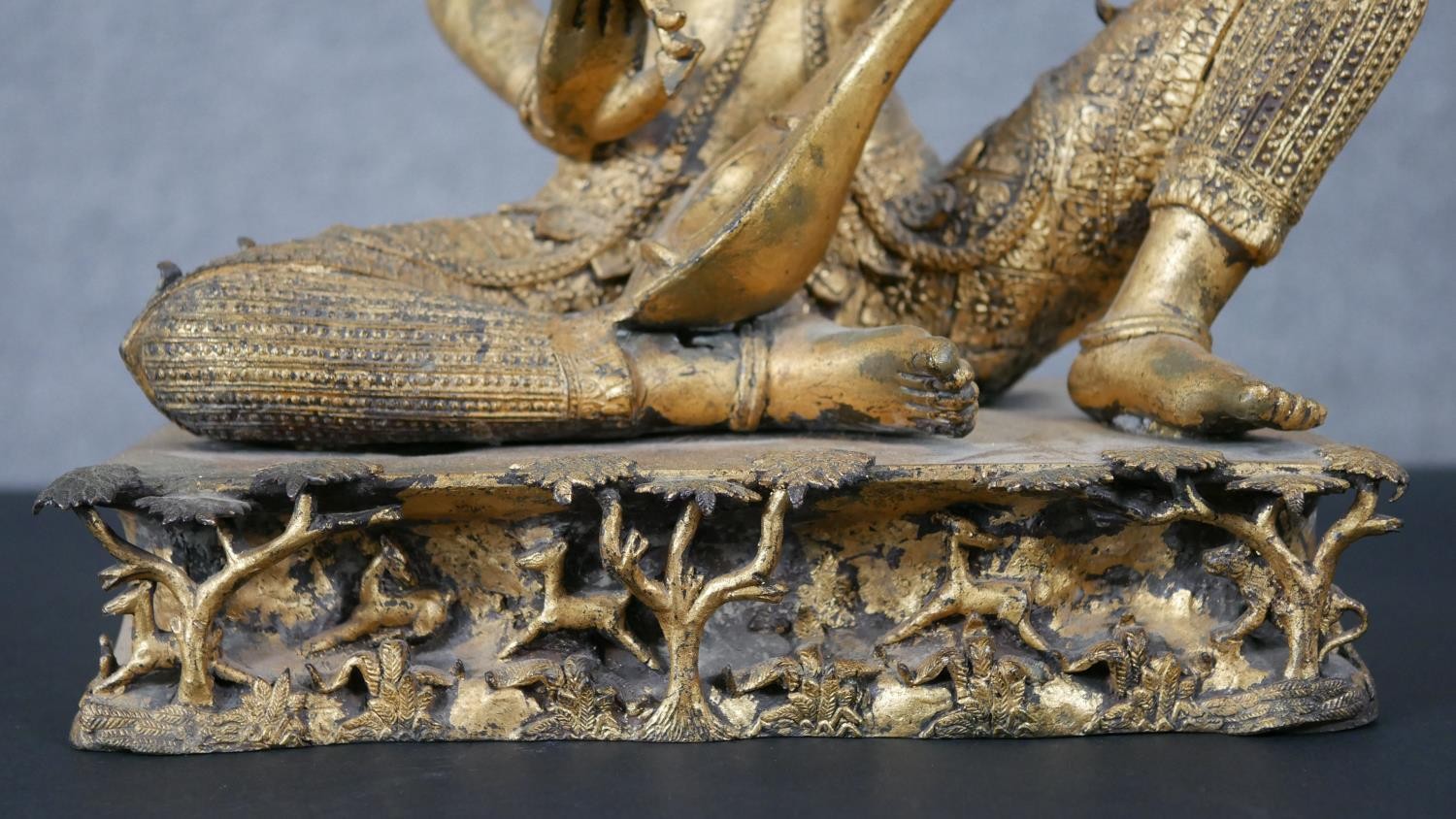 A 19th century gilded bronze Thai figure of Saraswati playing a vina. Animals and trees around the - Image 3 of 10