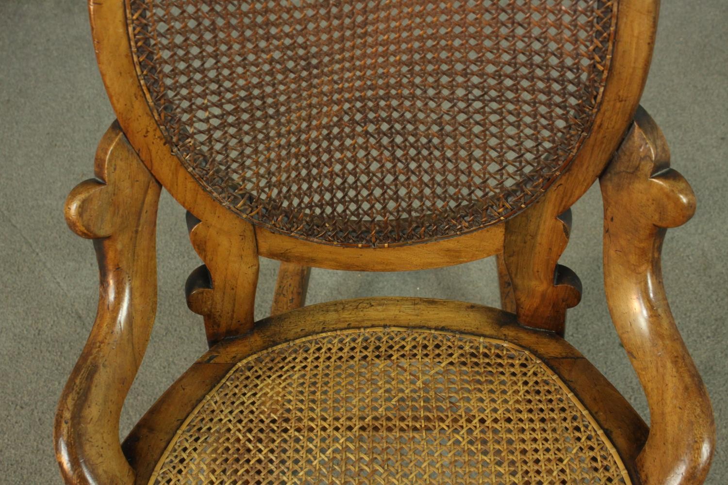 A fruitwood rocking chair, the oval back, and the seat both caned, on turned legs joined by - Image 5 of 6