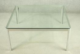 A steel coffee table, of square form with a plate glass top. H.39 W.92 D.92cm.