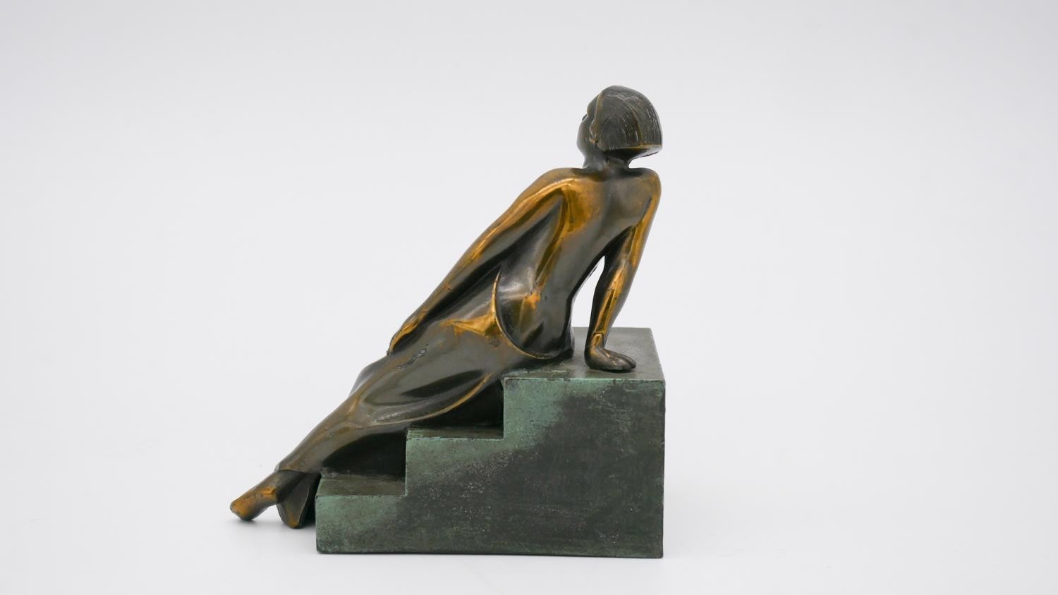 An Art Deco style patinated bronze of a woman reclining on steps. Unsigned. H.15 W.15 D.8cm - Image 5 of 7
