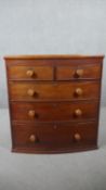 A Victorian mahogany bow front chest, with two short over three long cockbeaded drawers with