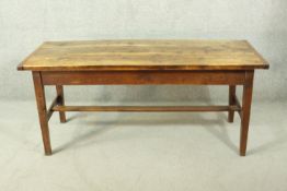 A French oak farmhouse dining table, the rectangular plank top with cleated ends, on square