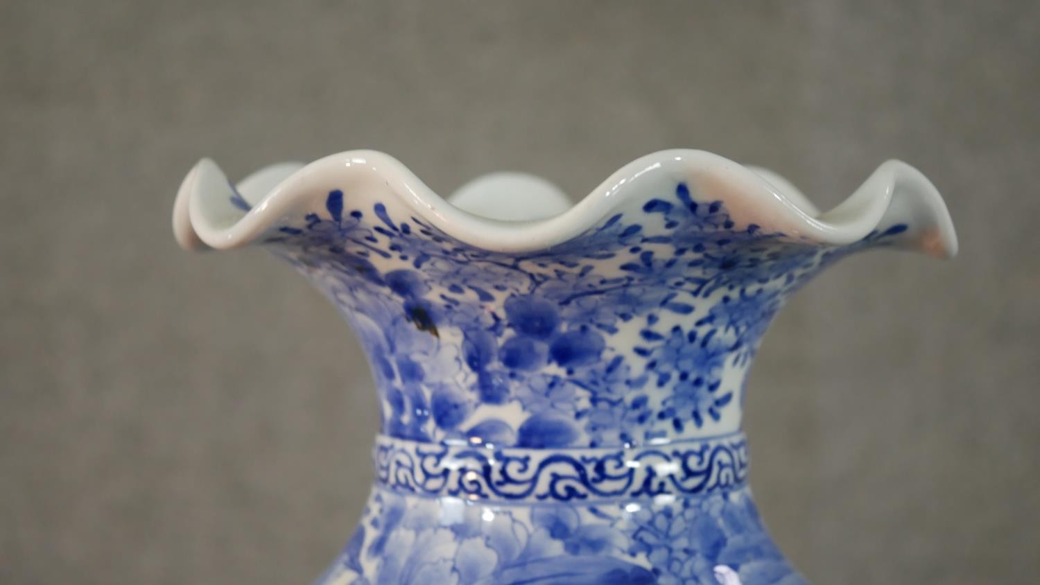 A large Japanese early 20th century blue and white hand painted porcelain vase with fluted edge. - Image 2 of 12