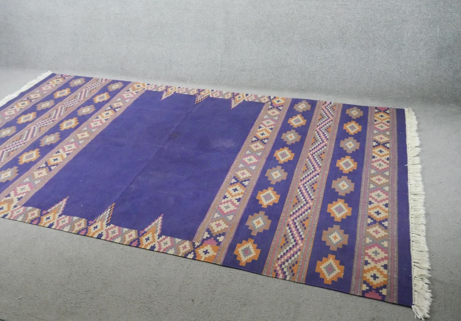 A Indian blue ground Dhurrie Kelim flat weave rug. L.275 W.85cm
