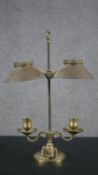 A 19th century brass double rise and fall student's candle lamp with scrolled arm supports. H.49 W.