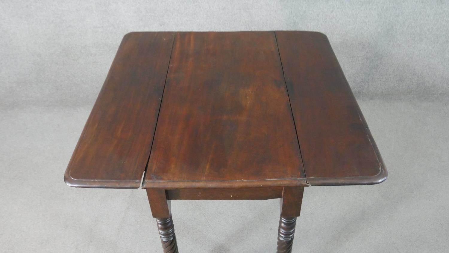 A Victorian mahogany drop leaf dining table, with turned and wrythen legs. H.70 W.93cm (Extended) - Image 7 of 7