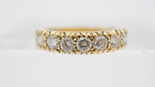 An 18 carat yellow gold and diamond half eternity ring set with seven round old cut diamond with a