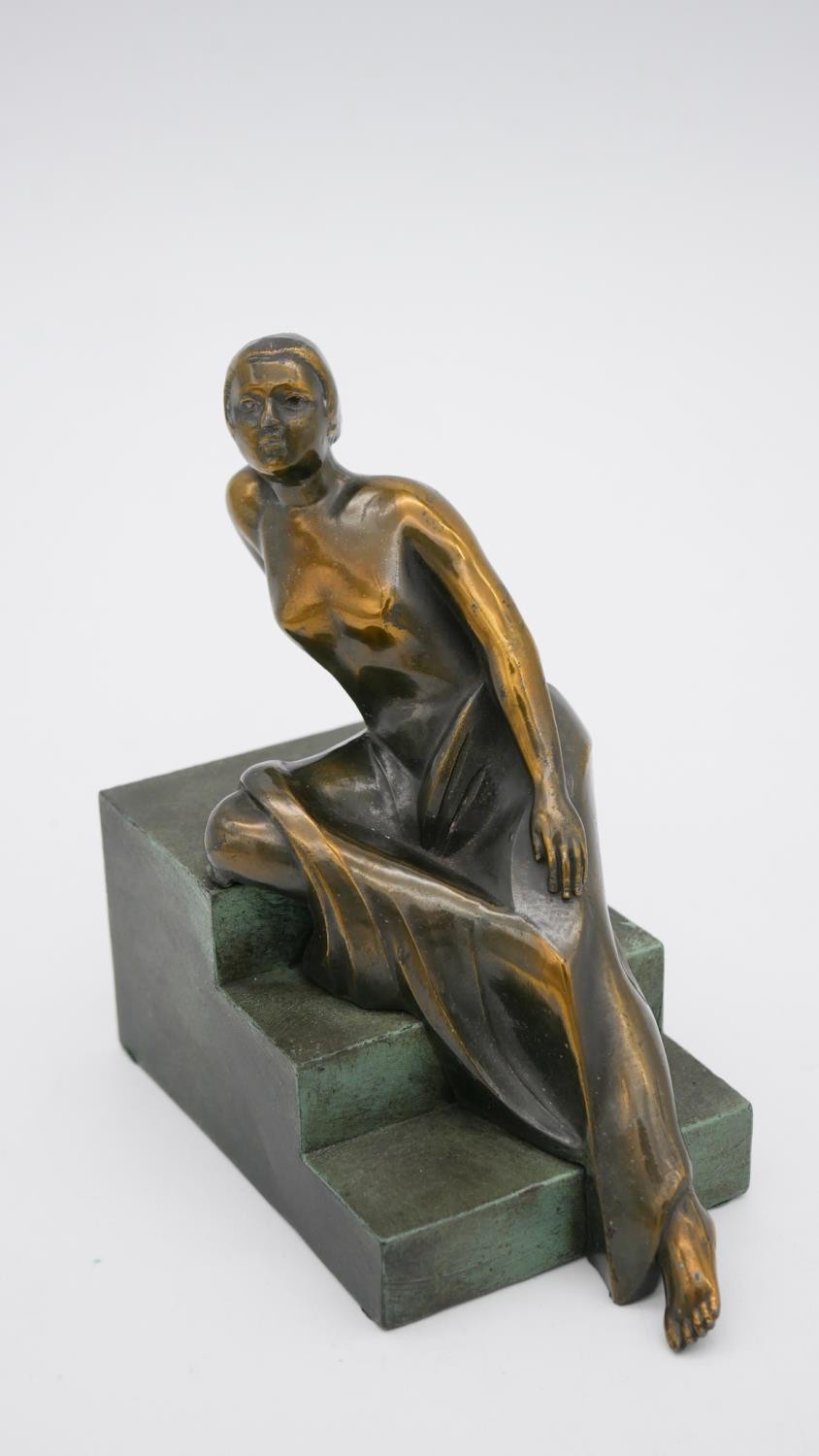 An Art Deco style patinated bronze of a woman reclining on steps. Unsigned. H.15 W.15 D.8cm - Image 3 of 7