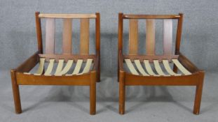 A pair of circa 1970s Ercol beech lounge chairs, with three angled back splats, without the loose