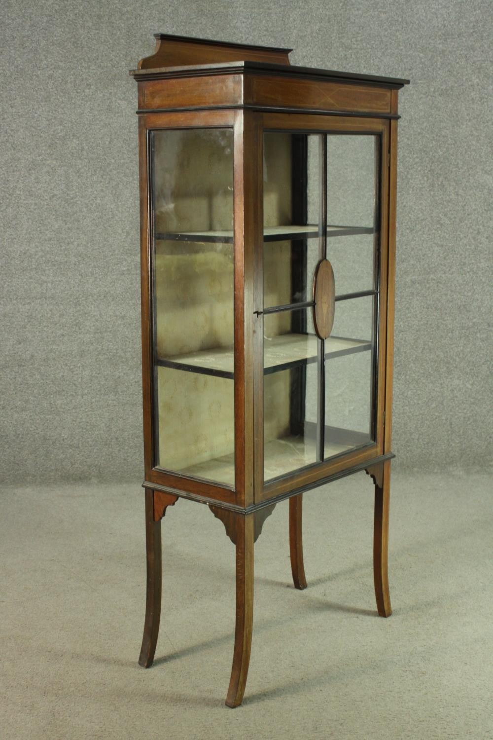 An Edwardian walnut display cabinet, with a gallery top, over a glazed door and sides, enclosing - Image 5 of 7