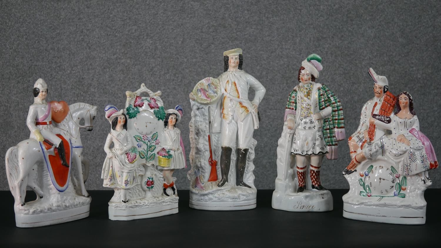 A collection of four 19th century flat back Staffordshire pottery figures, including Robert the