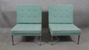 A pair of Florence Knoll parallel bar lounge chairs, upholstered in blue fabric, with tufted back