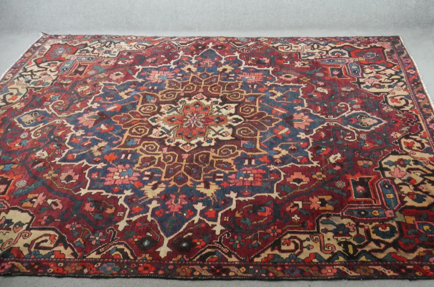 A vintage red ground hand made Persian Hamadan carpet. L.295 W.220cm