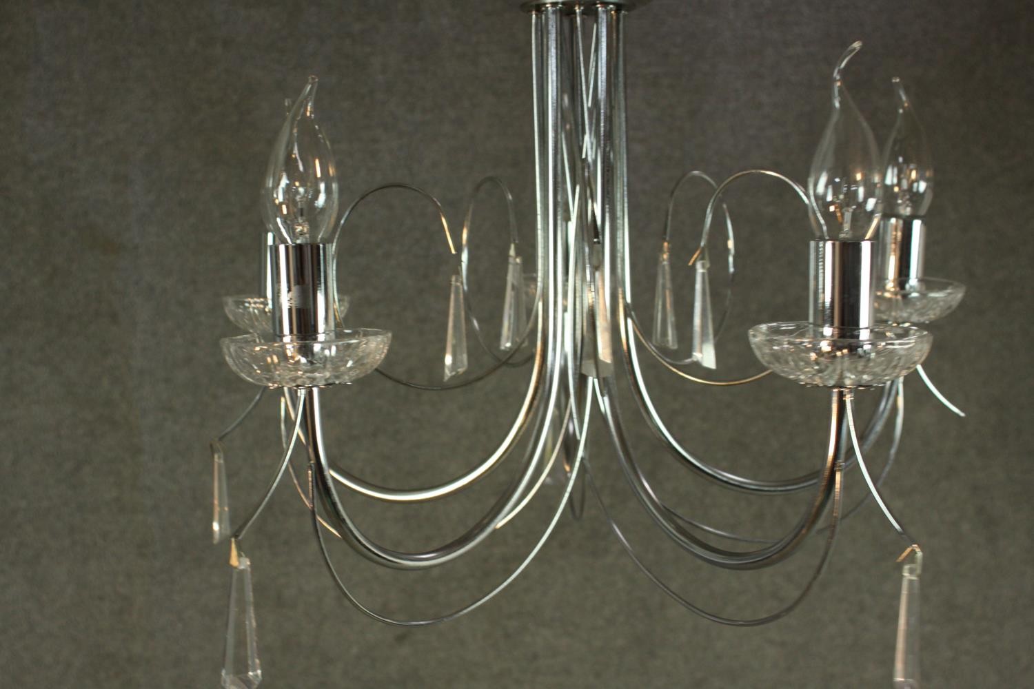 A contemporary chrome chandelier, with five curved branches and glass drip trays. H.37 W.43cm. - Image 3 of 4