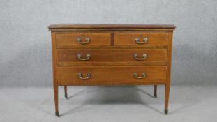 An Edwardian mahogany chest of two short over two long drawers, on slender square section tapering