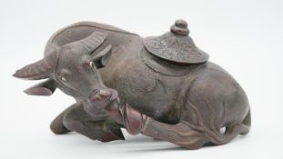 A 19th century Chinese carved hardwood buffalo with glass eyes. (Split and both horns damaged) H.