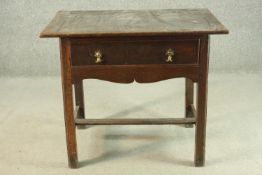 An 18th century oak side table with a rectangular top over a single drawer above a curved apron, the
