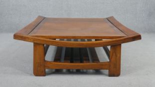 An Eastern elm coffee table, contemporary, the square top with raised sides, over a slatted