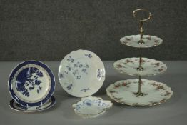 A collection of porcelain, including a three tiered floral design cake stand with gilt metal handle,