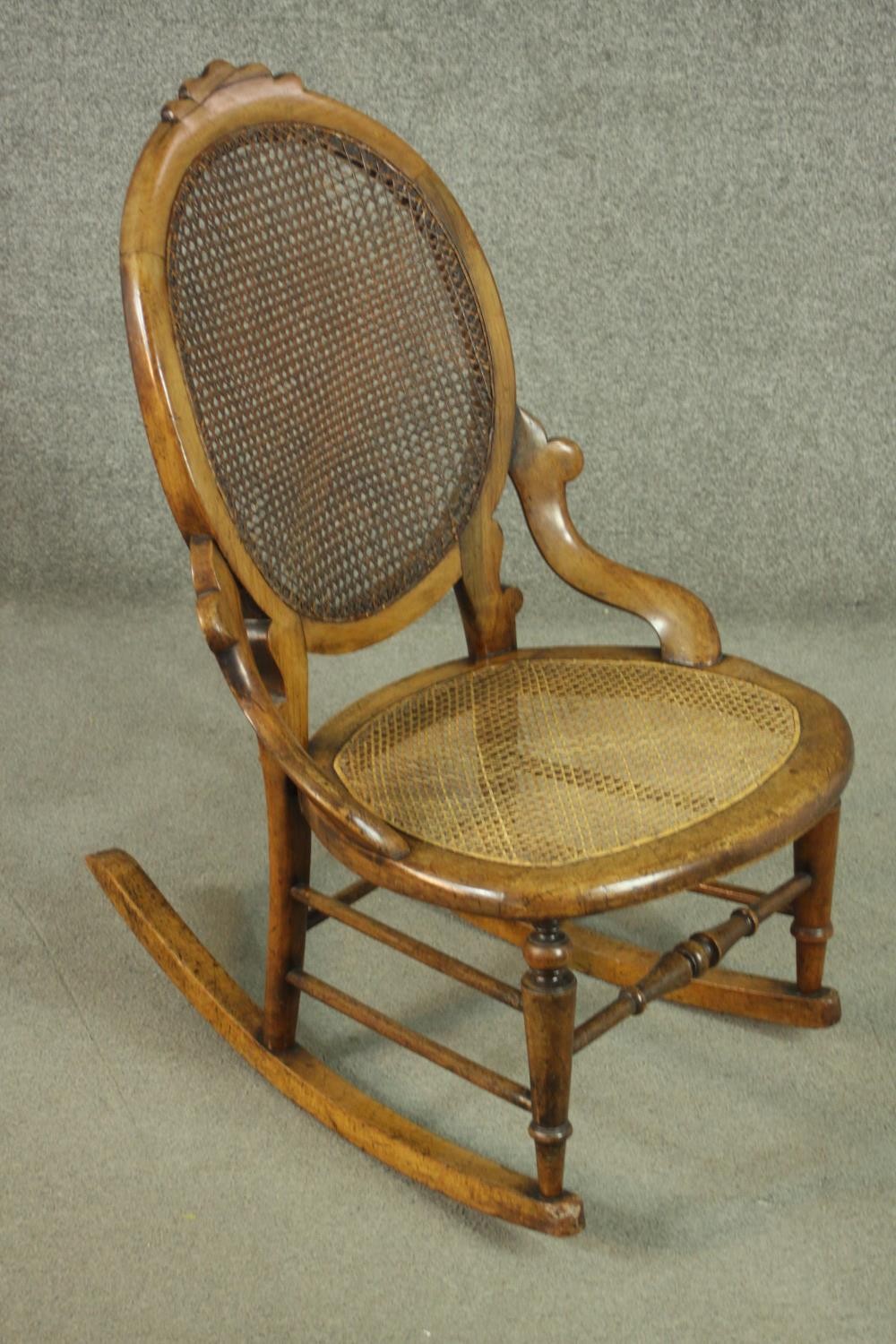 A fruitwood rocking chair, the oval back, and the seat both caned, on turned legs joined by - Image 2 of 6