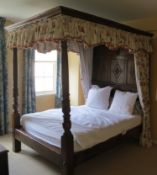 A 17th century style oak four poster bed, the headboard of panelled construction, three panels