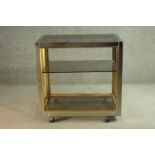 Manner of Janetti, a 1970's trolley, with a tinted glass coffee top and undertiers on a chrome and