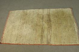 A beige ground Persian Gabbeh rug. L.130 W.86cm